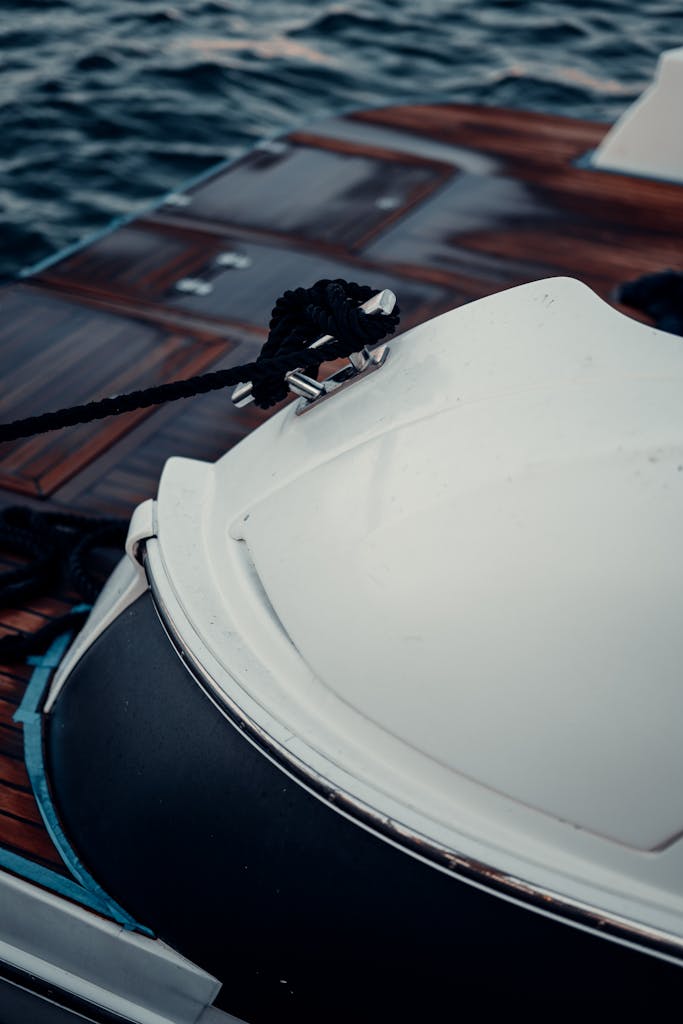 Close-up view of a yacht's deck with mooring ropes secured, highlighting nautical design.
